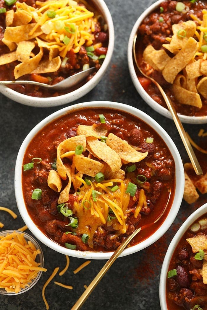 The best chili recipe you'll ever eat is right here! Our classic beef chili is made with ground beef, beans, diced tomatoes, and a homemade chili seasoning. bowl of beef chili with cheese on top.