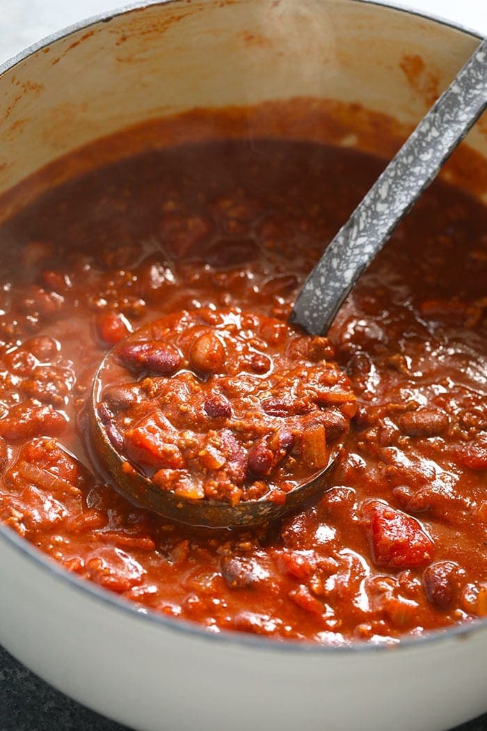 The best chili recipe you'll ever eat is right here! Our beef chili is made with ground beef, beans, diced tomatoes, and DIY chili seasoning. stockpot of the best chili recipe.