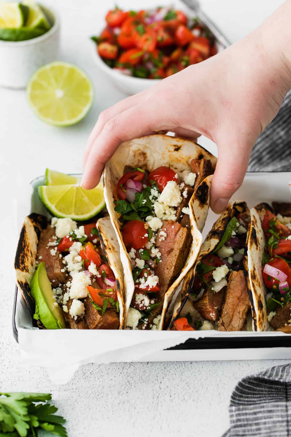 This super flavorful steak taco seasoning comes together in just 7 ingredients you likely have on hand in your spice cupboard already. steak taco being picked up about to be eaten