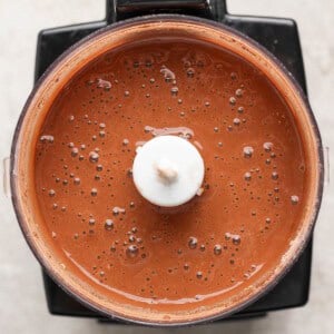 A blender filled with smooth, chocolate-colored liquid viewed from above.