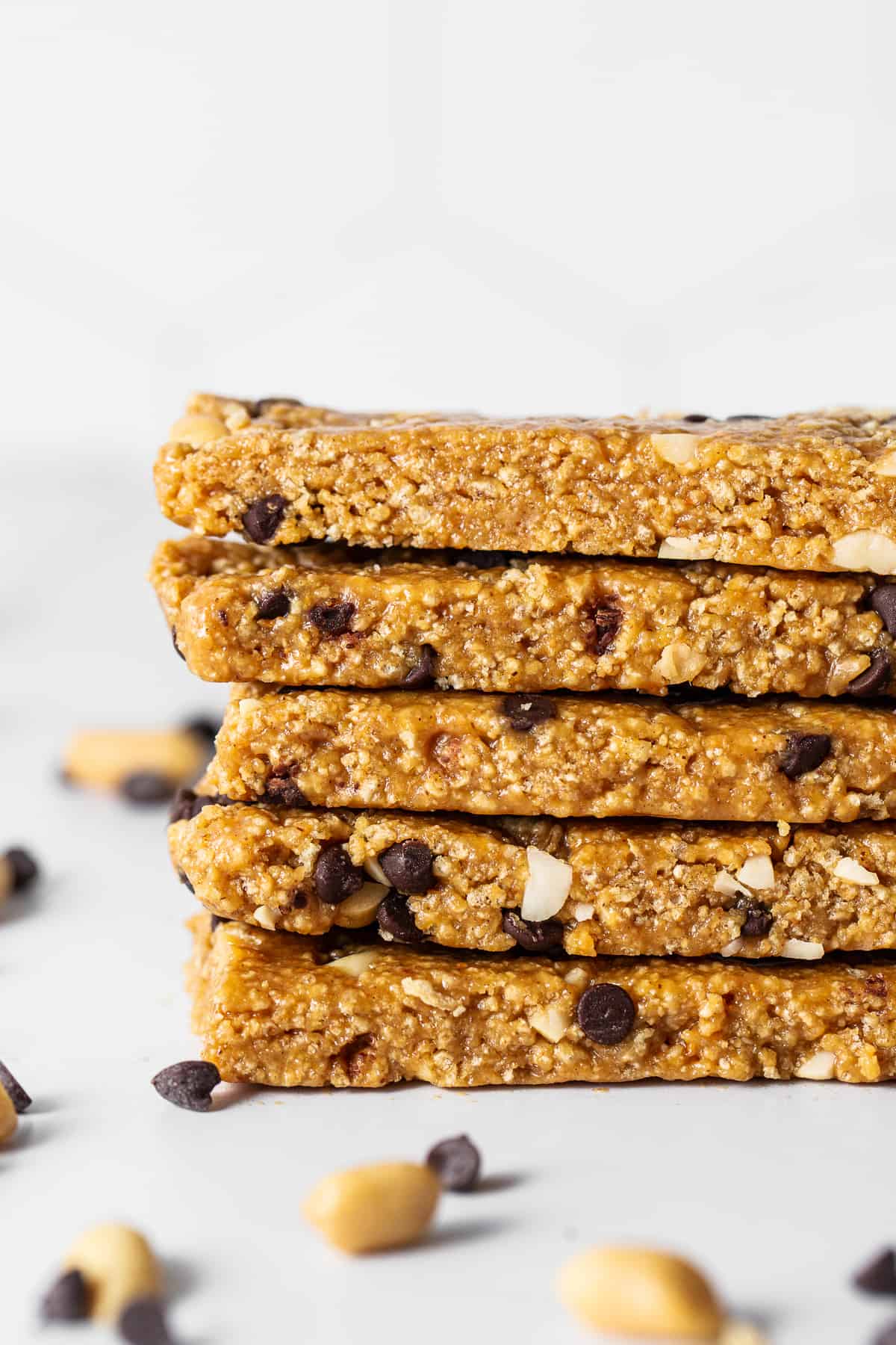 Want a healthy, protein-packed snack on the go? These no bake peanut butter bars will be your new favorite treat! They're crunchy, sweet, salty, and ridiculously easy to make. No bake peanut butter bars stacked on a plate.