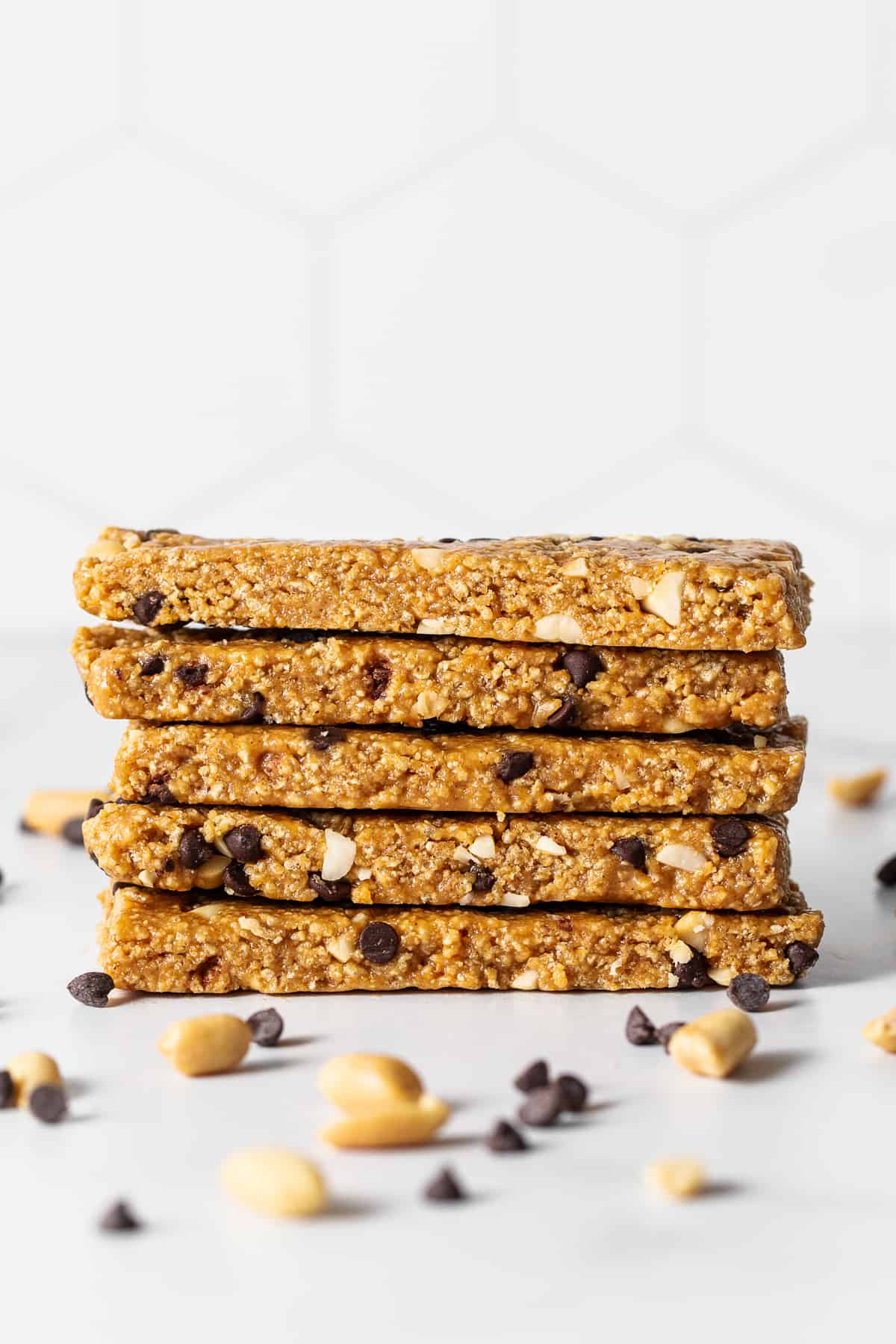 Want a healthy, protein-packed snack on the go? These no bake peanut butter bars will be your new favorite treat! They're crunchy, sweet, salty, and ridiculously easy to make. No bake peanut butter bars stacked on a plate.