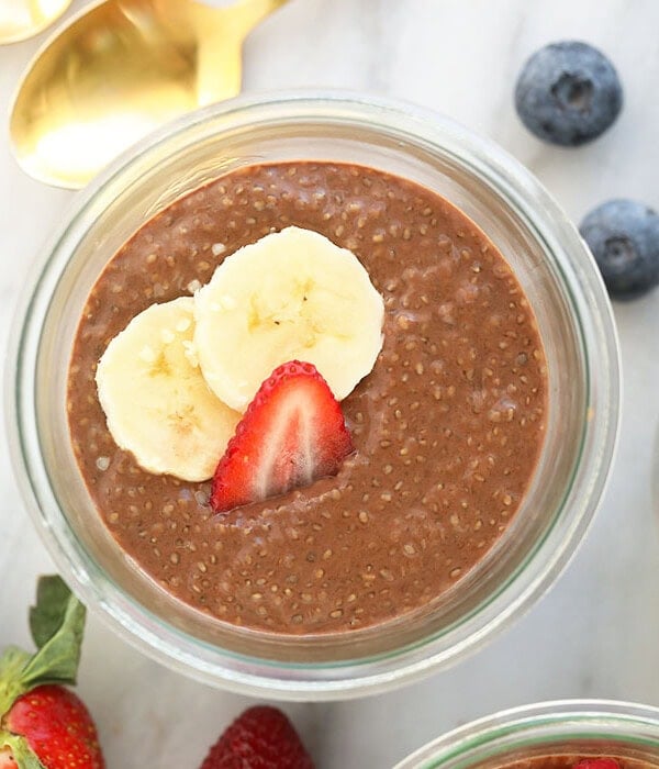Three jars of protein-packed chia seed pudding with berries and bananas.