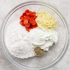 Glass bowl with pizza protein bagel dough ingredients mixed together