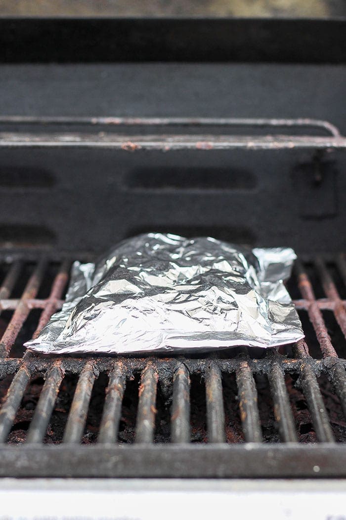 Grilled potatoes in foil — crispy, easy, and ready in 30 minutes! The perfect summer side dish for cookouts, camping, and weeknight grilling. foil pack of potatoes on grill