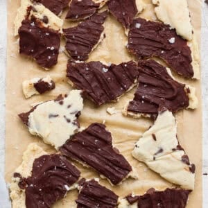 cottage cheese cookie dough bark broken into pieces on parchment paper