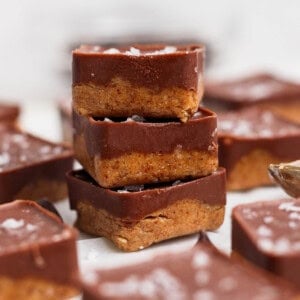 stack of three thin mint protein bites showing chocolate layer and fudgy almond butter base