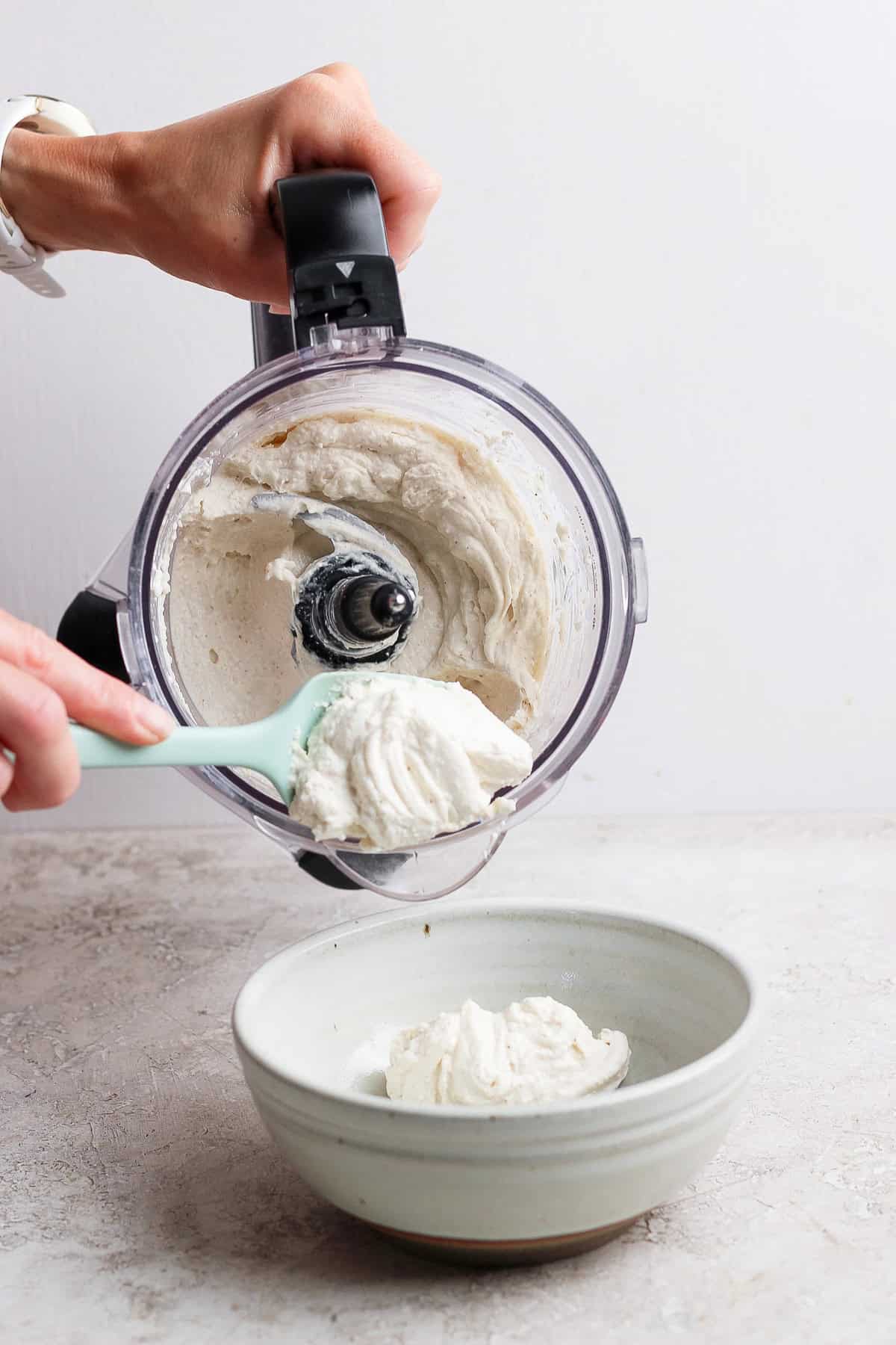 scooping blended apple dip into serving bowl