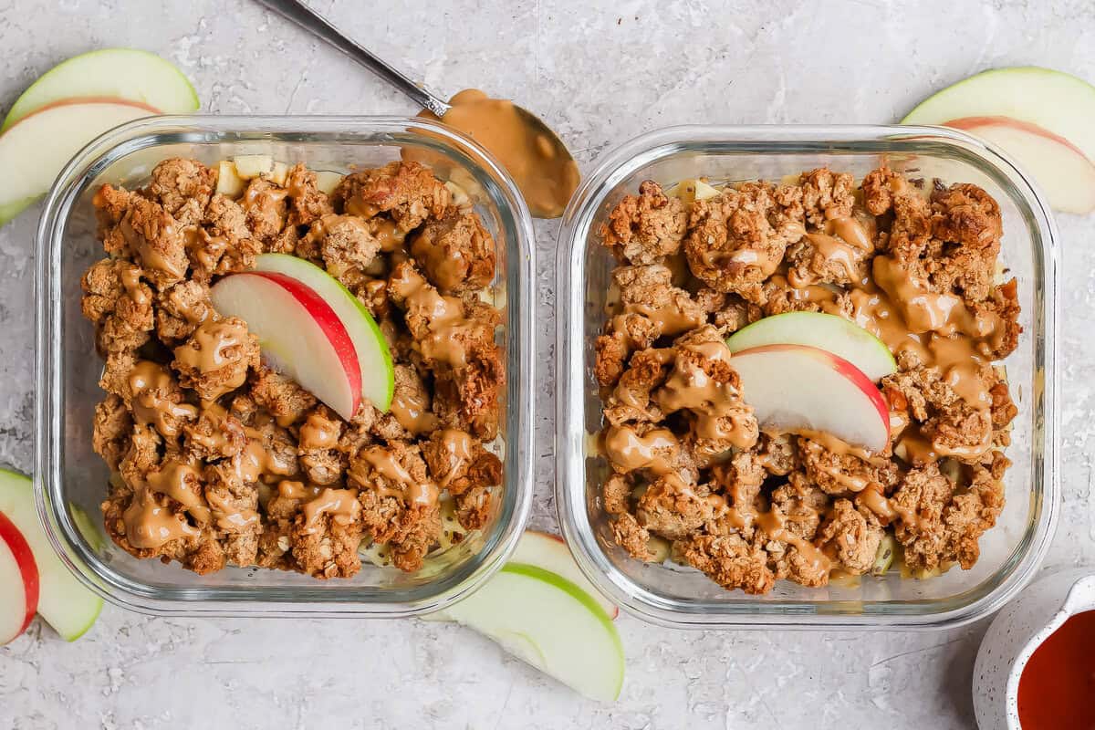 Two individual protein apple crisps topped with nut butter and sliced apples.